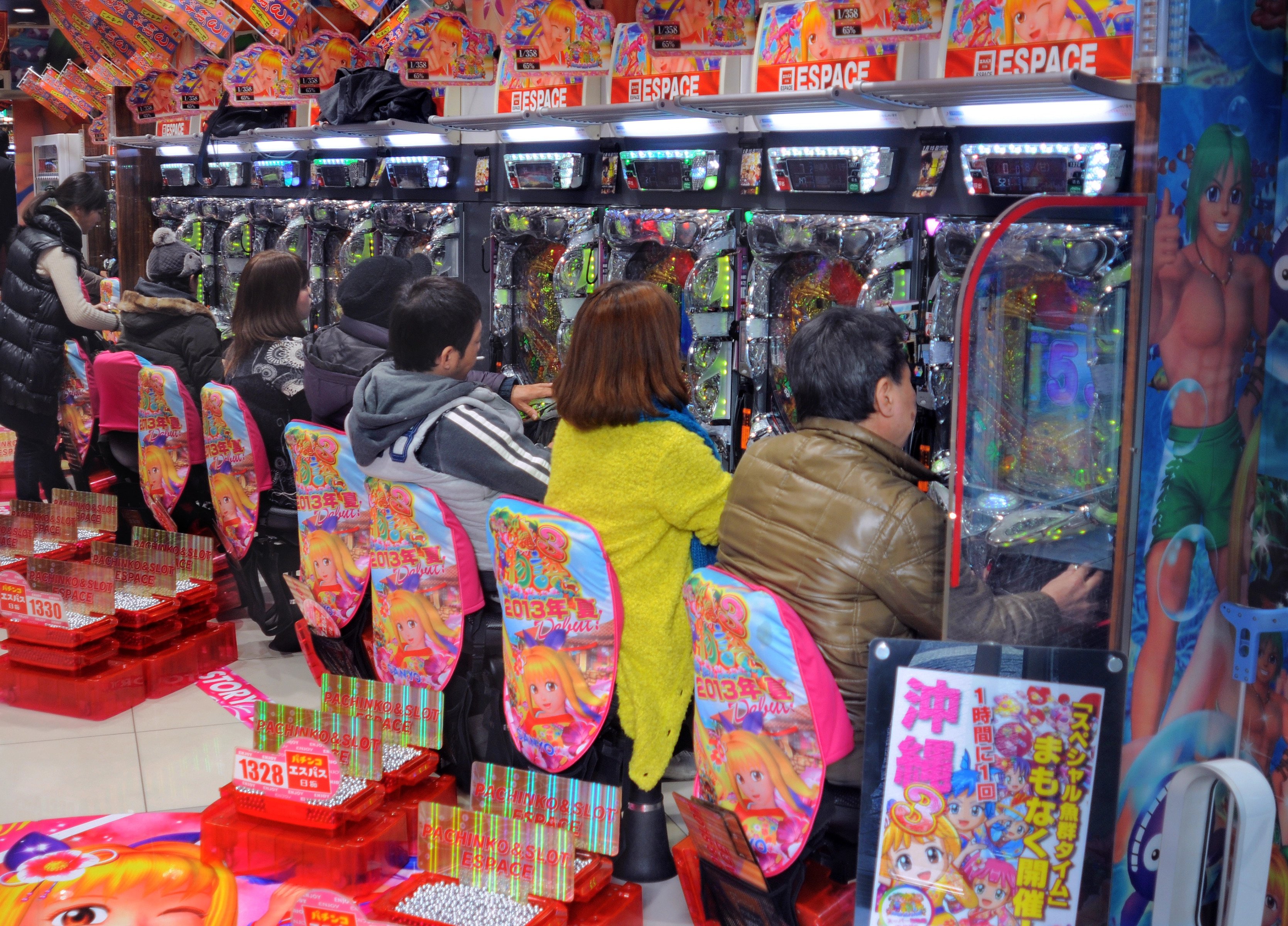 People playing pachinko on the Pachinko machines