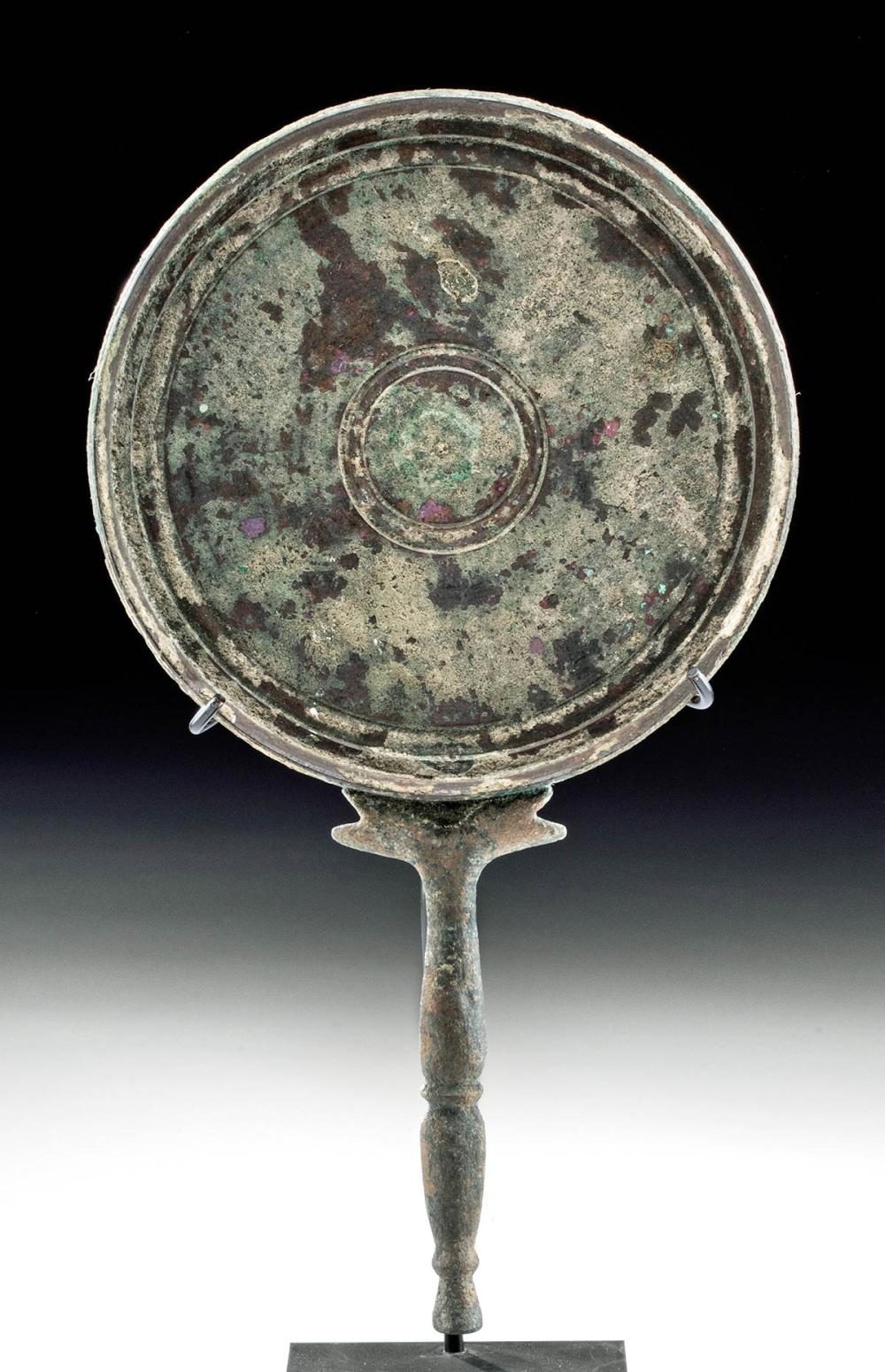 An ancient mirror stand made of metal
