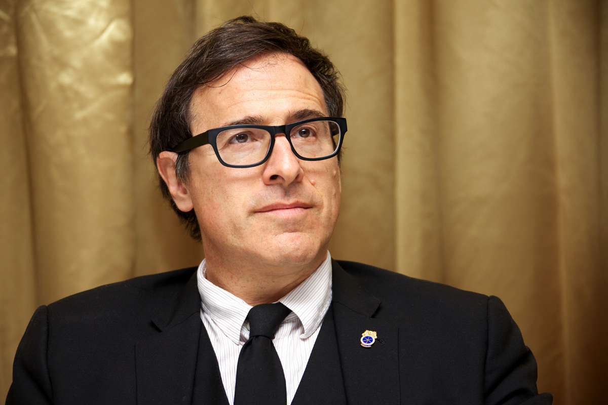 David O. Russell in a black suit and black eye glasses