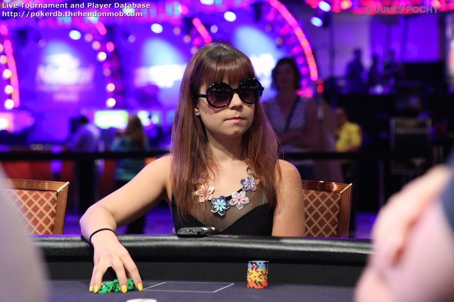 Annette Obrestad wearing a black sun glasses while covering a stack of chips on her right hands