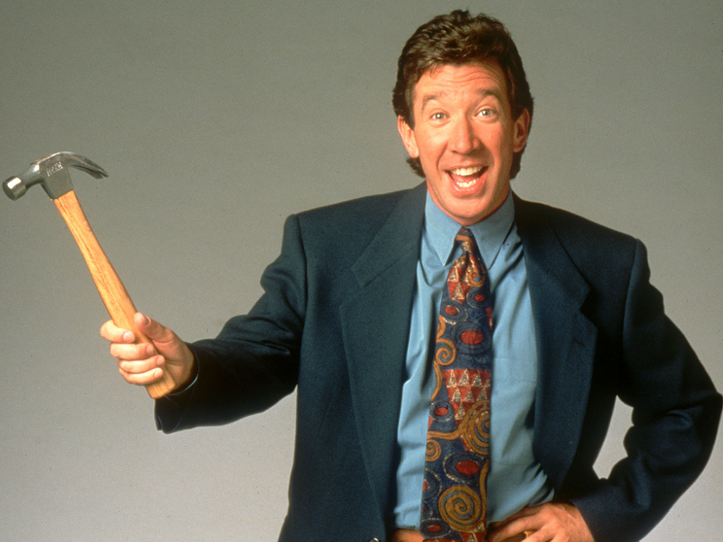 Young Tim Allen holding a hammer