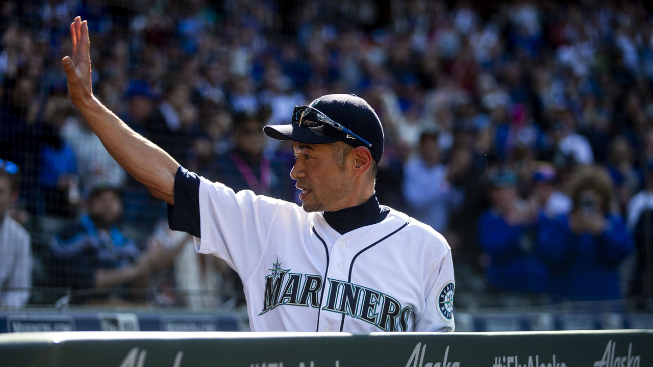 Ichiro Suzuki in white Mariners uniform waving his right hand during a match