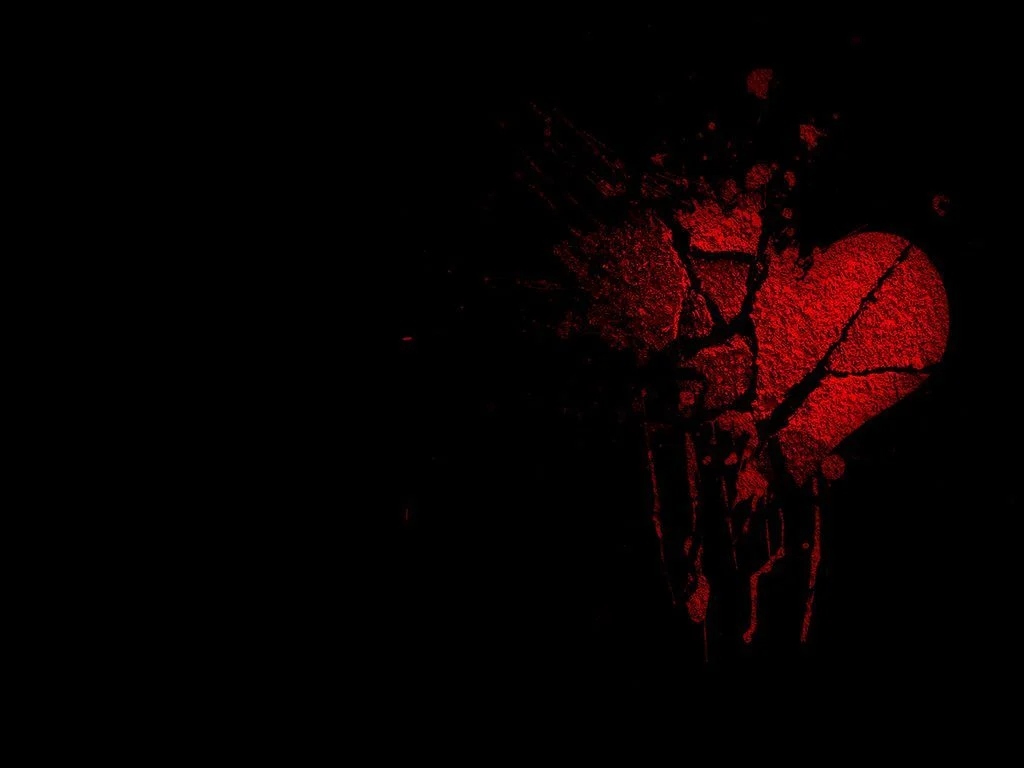 Red-colored heart broken on a black background