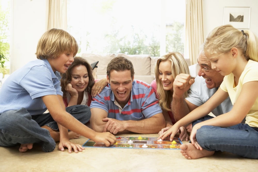 A family enjoying and playing a board game