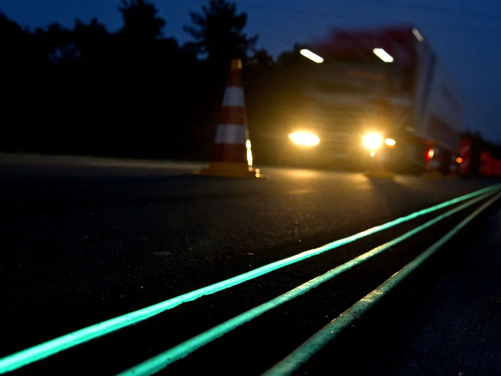 A truck running on glow-in-the-dark road
