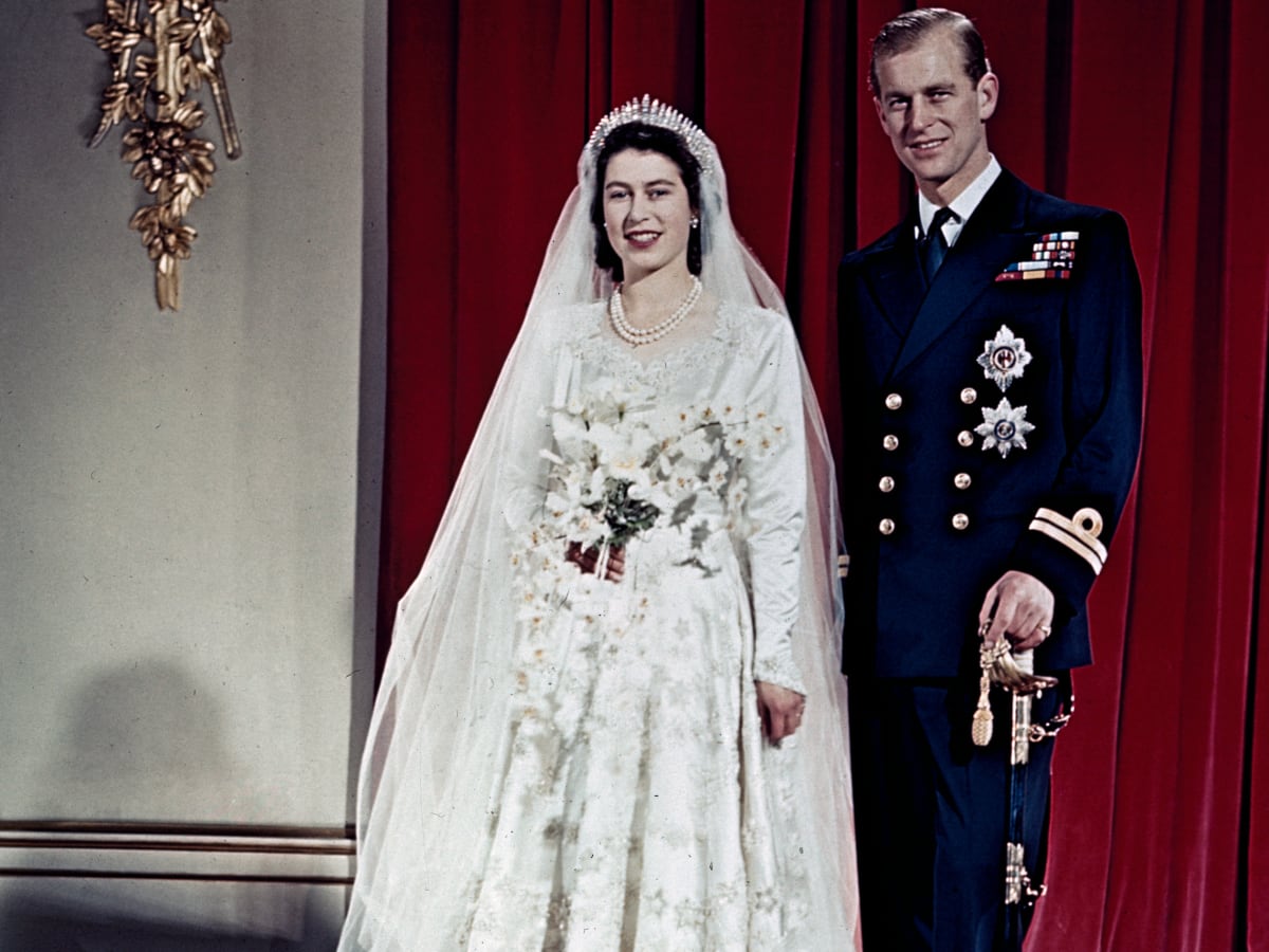 Queen Elizabeth II and Prince Philip standing and posing for a wedding picture