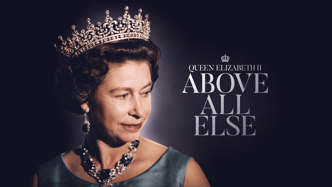 Queen Elizabeth II wearing a blue-green dress and crown