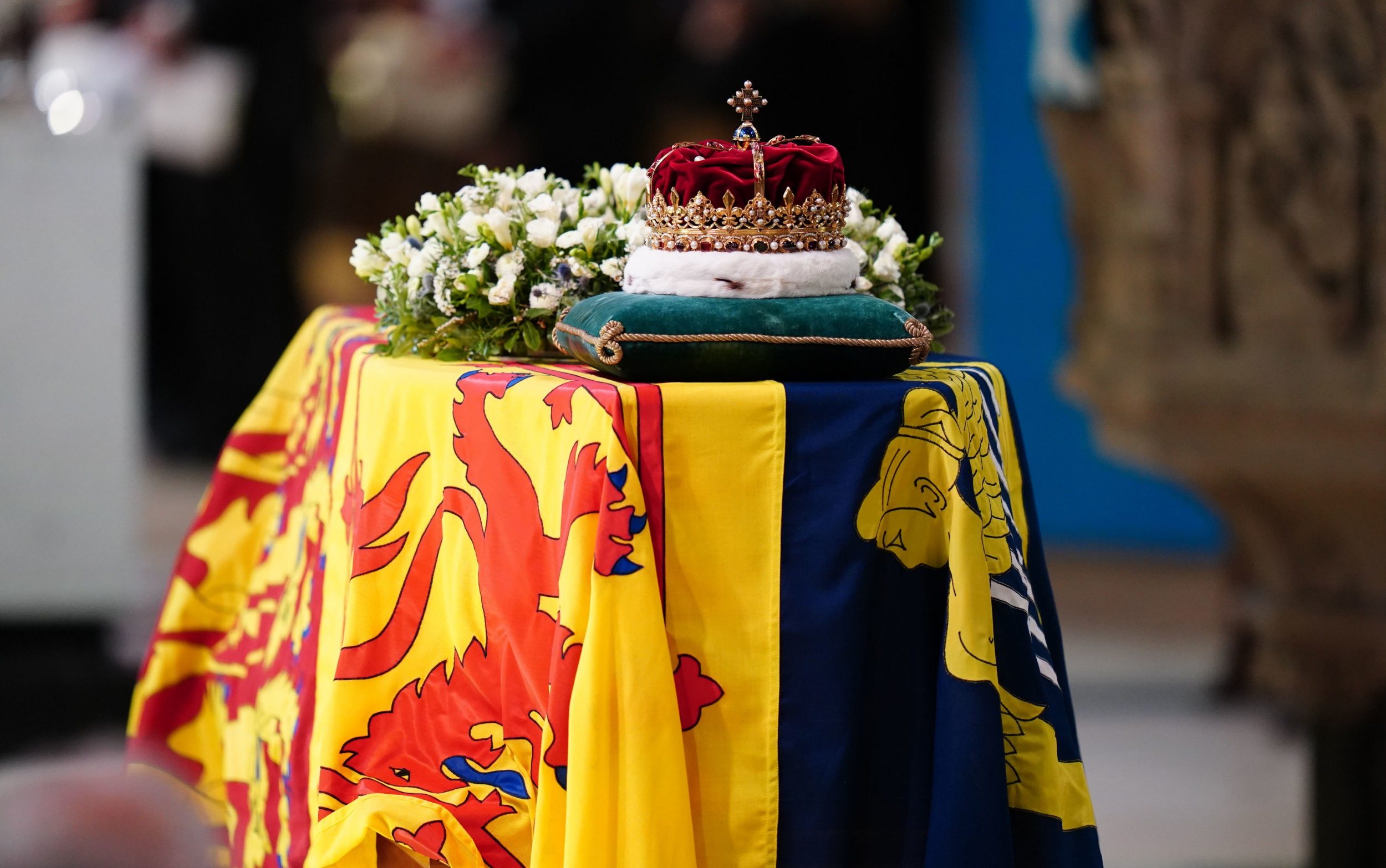 White flowers and queen's crown on the coffin