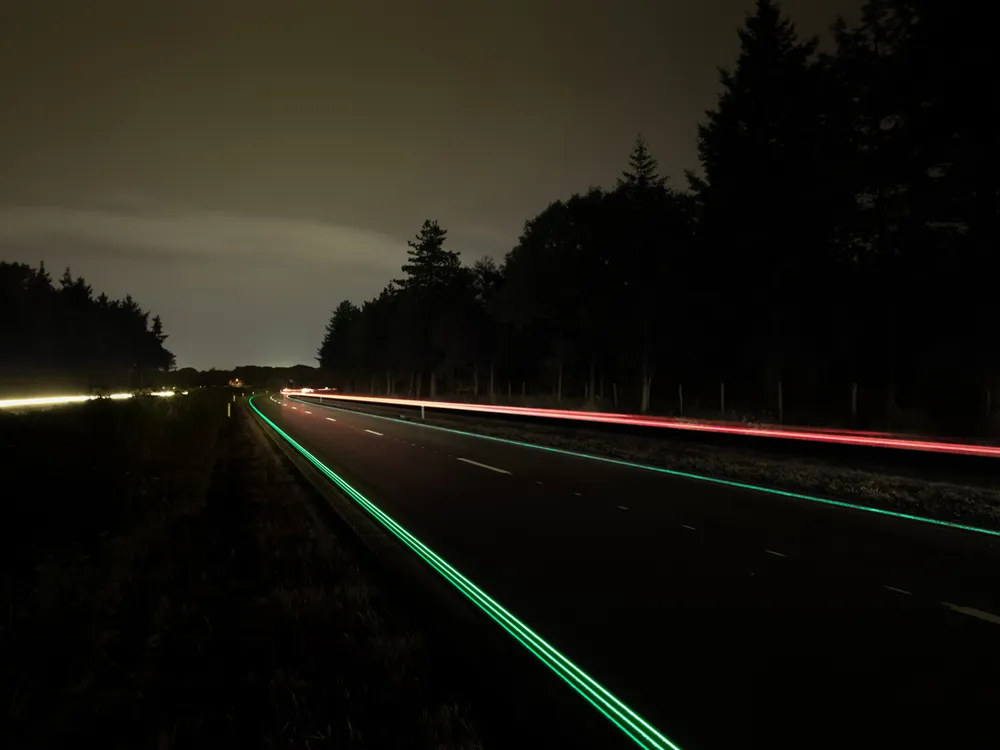 A beautiful view of green and red glowing lines on the road