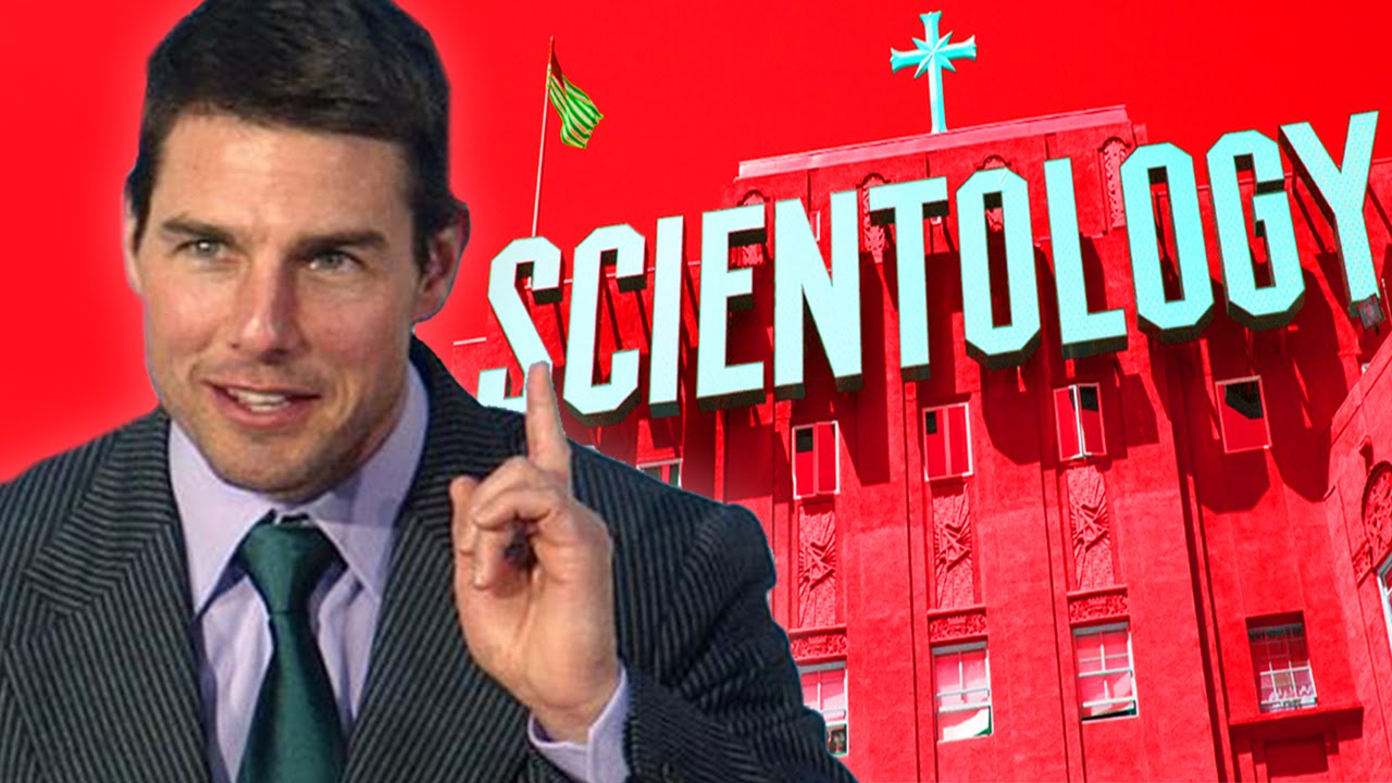Tom Cruise wearing a suit with red background of scientology