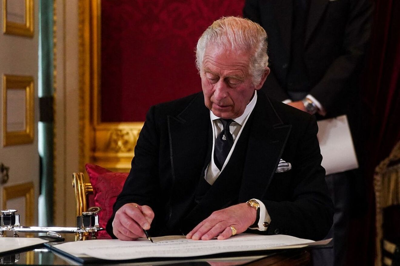 Prince Charles signing some papers