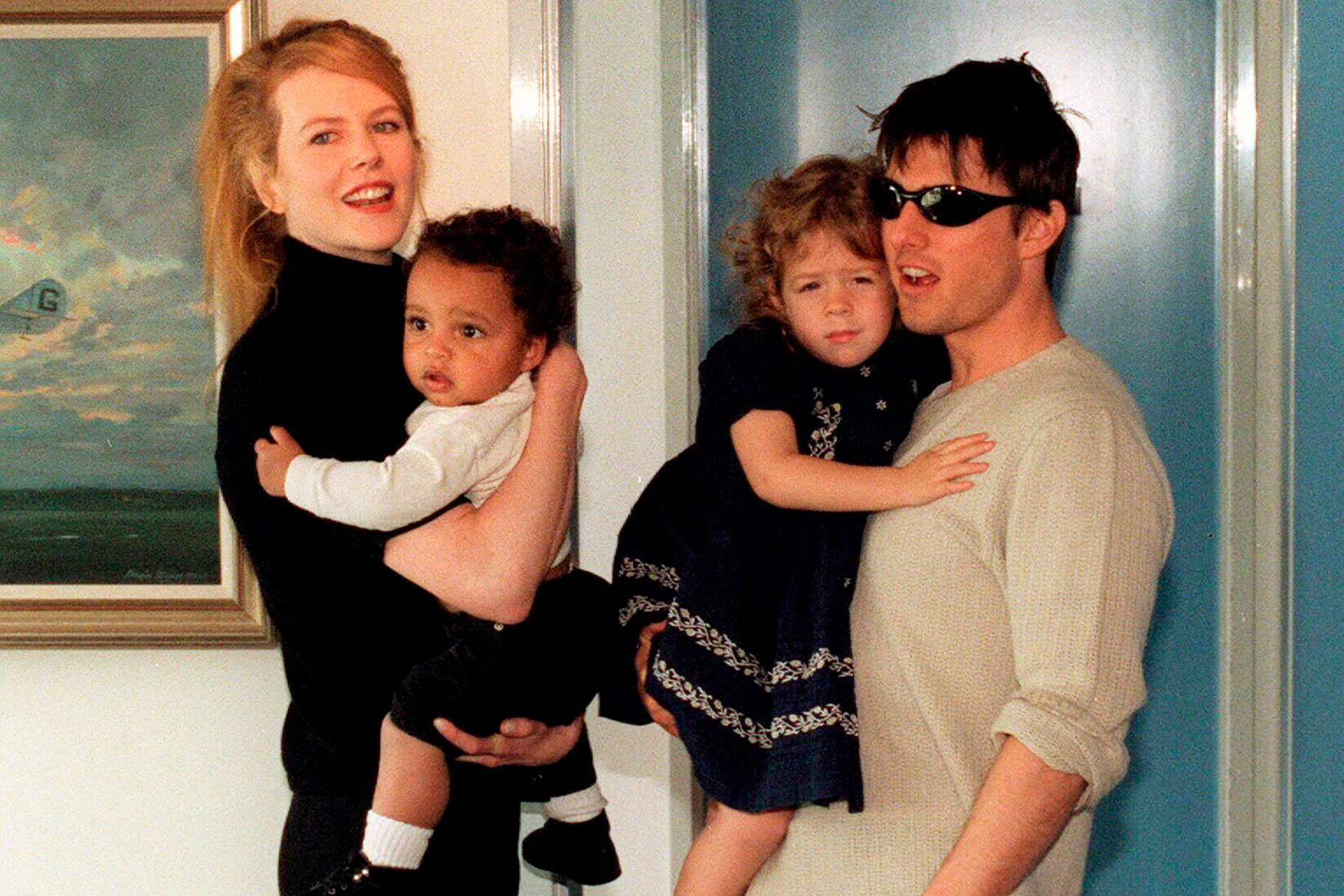 Tom Cruise and Nicole Kidman holding their adopted children
