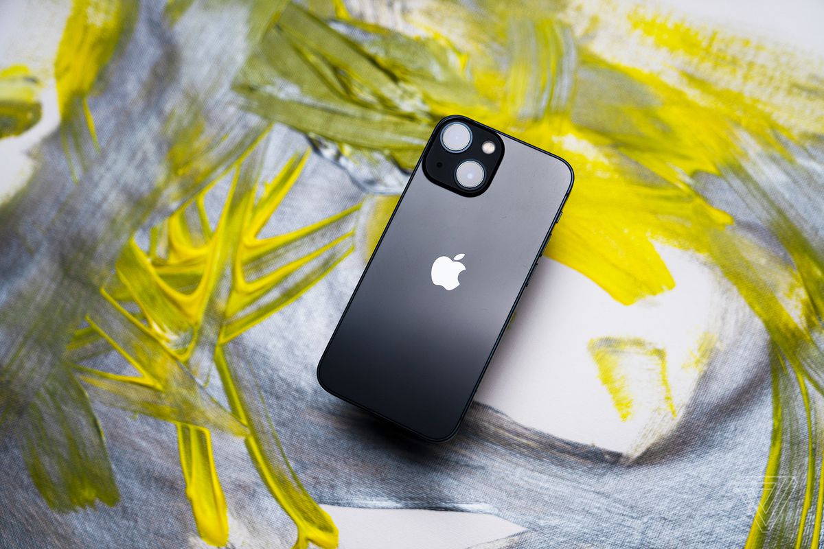 Black iphone on a grey and yellow background