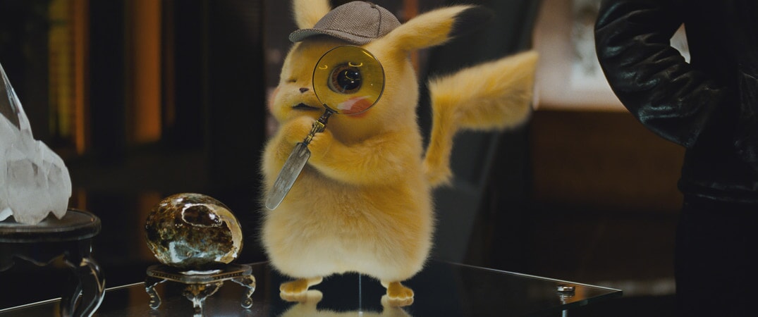 Detective Pikachu holding a magnifying glass