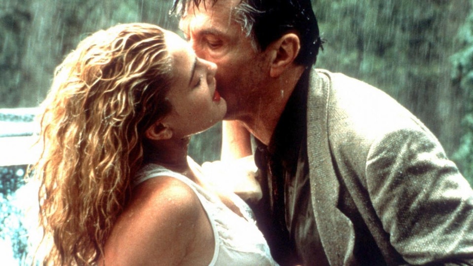 Two people kissing while raining
