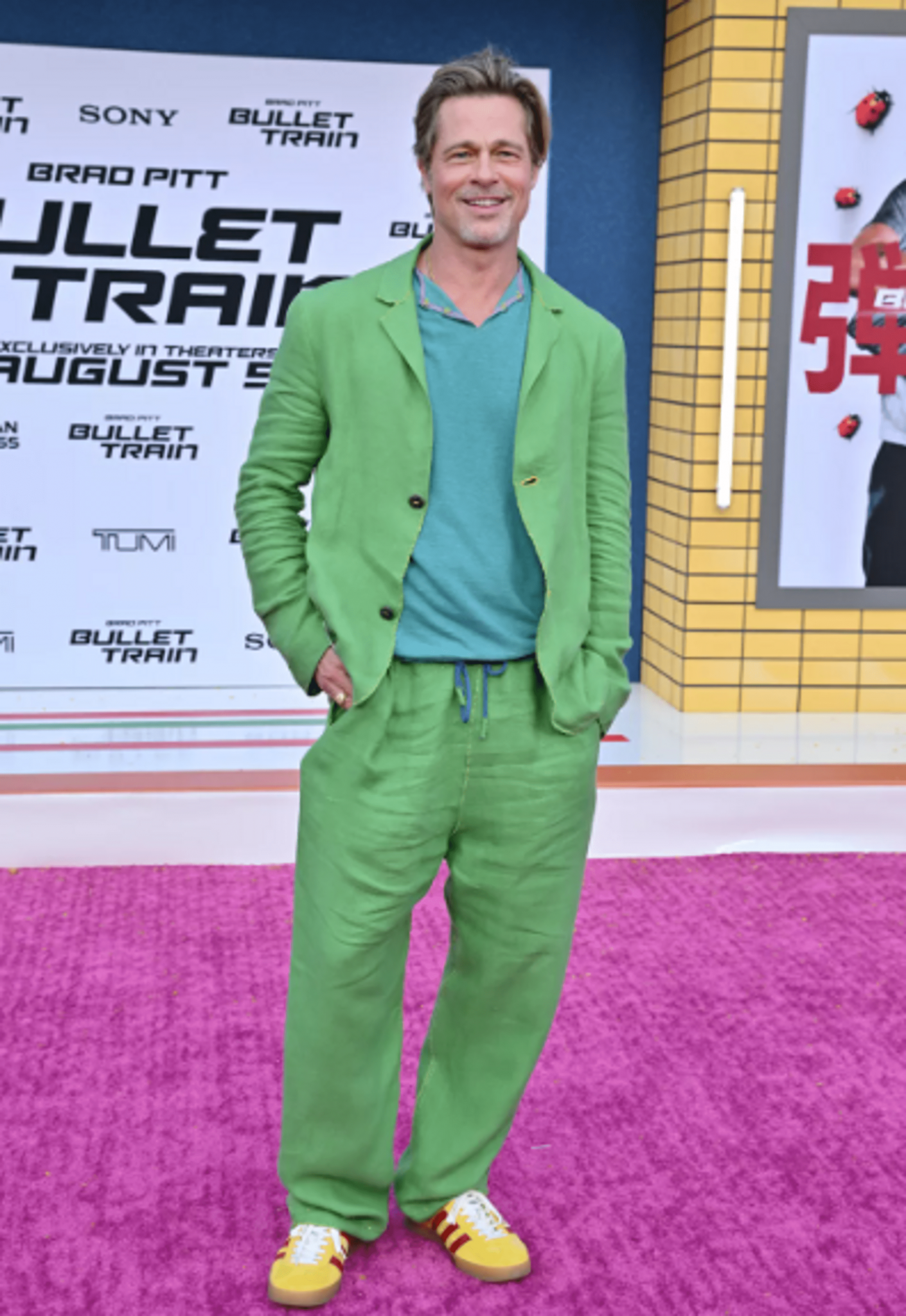 Brad Pitt wearing a green chic outfit at the premiere of "Bullet Train"