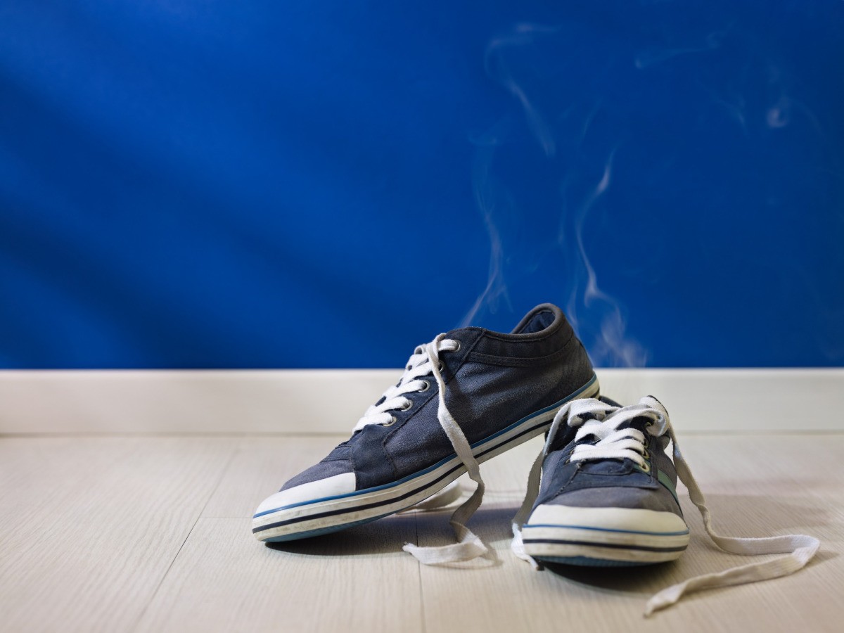 A pair of shoes on the surface of a table with visible vapor coming from the interior of the shoes