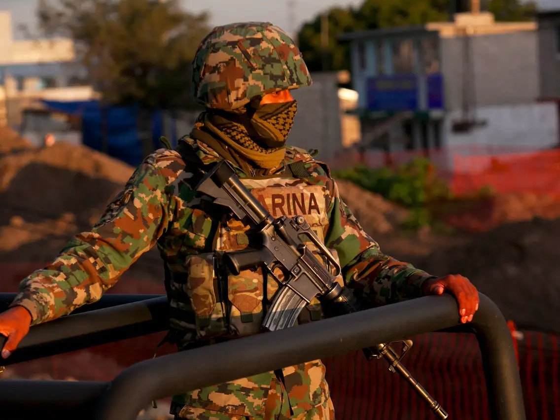Mexican army soldier standing in jeep