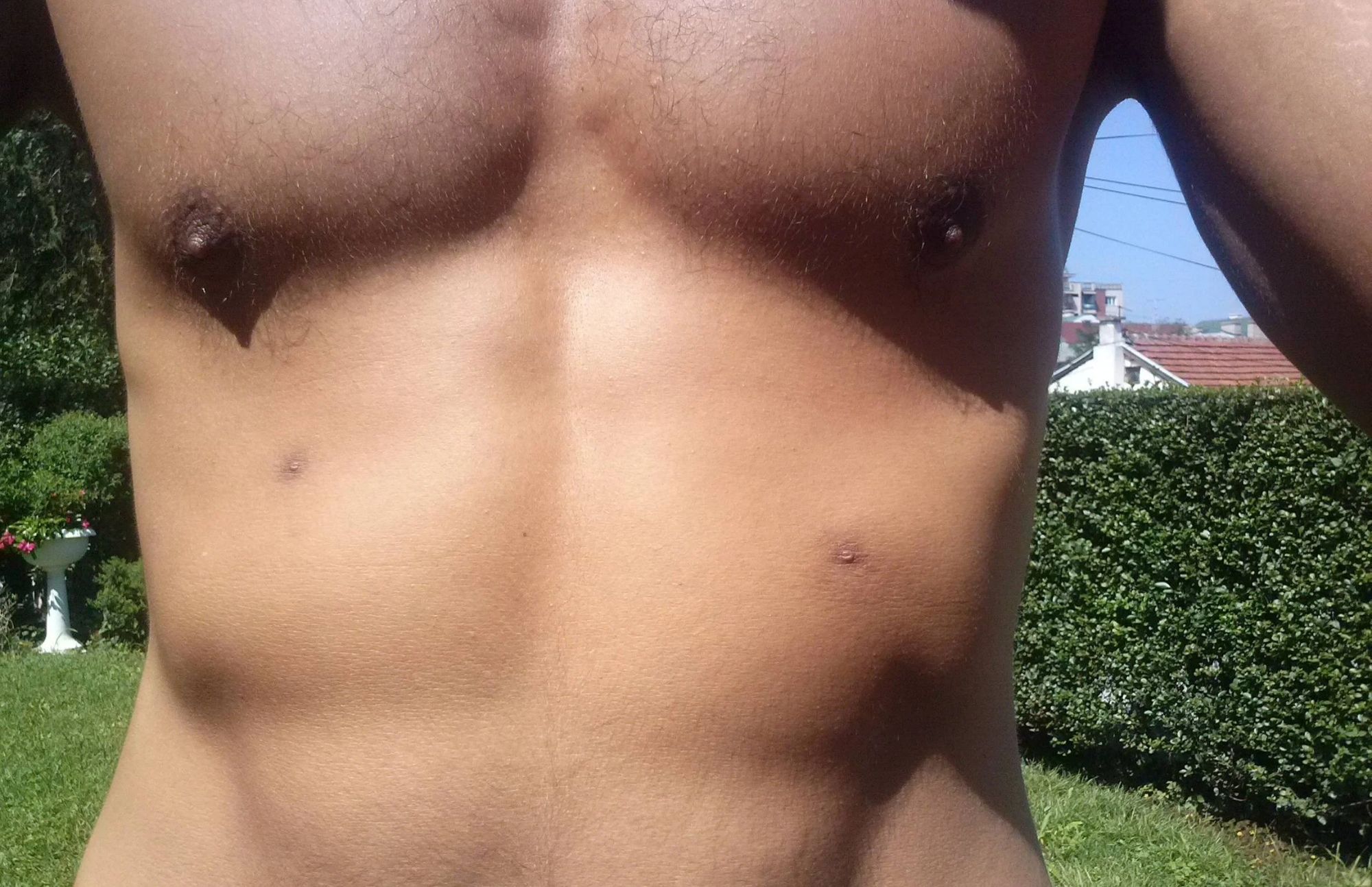 A man showing his two nipples and an extra pair of small nipples are located in his abdomen