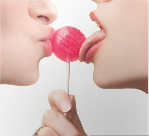 Two people sucking a lollipop