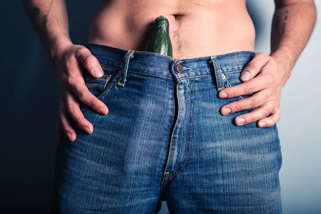 A man carrying a cucumber in his jeans