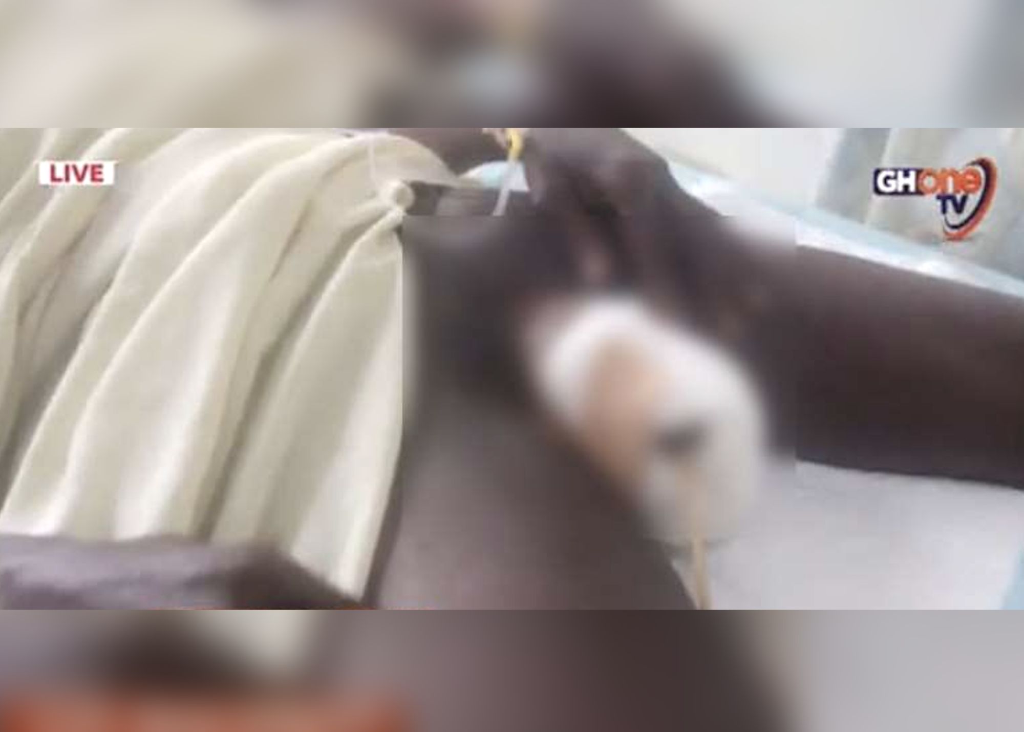 A black man named Kofi Atta shows his genitals wrapped by bandage