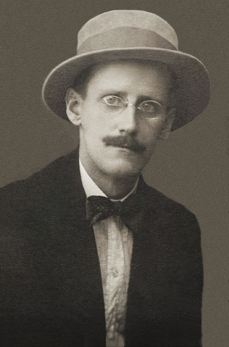James Joyce wearing round glasses and a hat