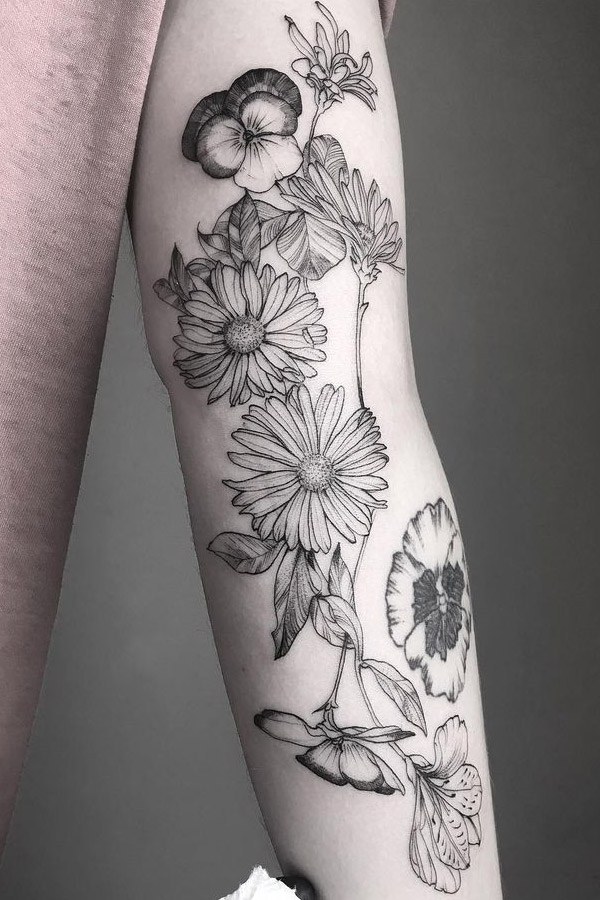 Black Aster flower tattoo on the arm