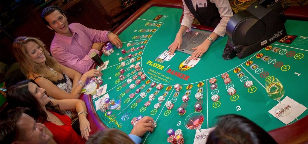 A group of people playing baccarat in casino