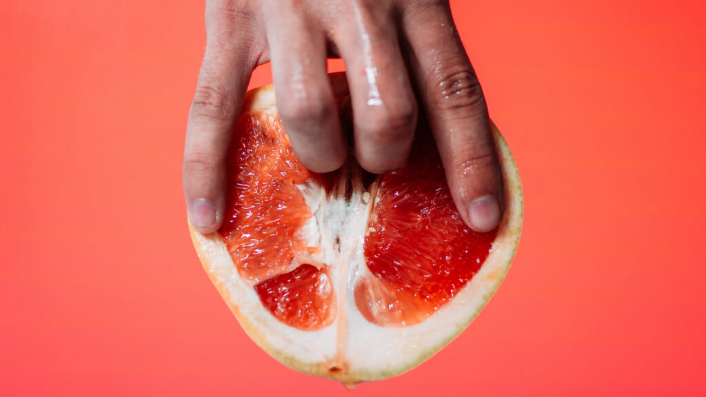 A Man Fingering A Grapefruit