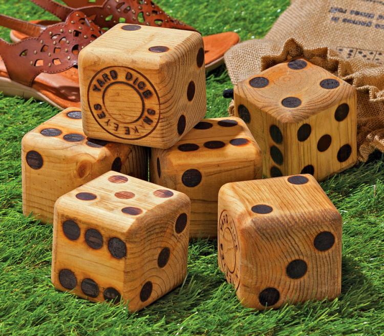 Giant wooden cushion cover dices in the ground