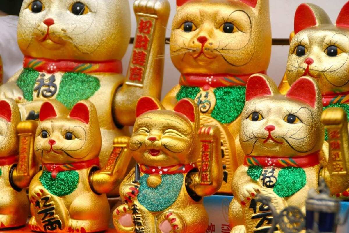 Golden-colored toy cats representing Chinese lucky symbol for gambling