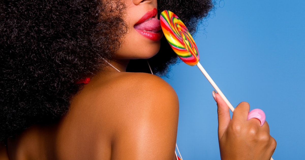 A Woman Practicing Oral Sex On A Candy