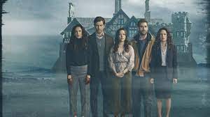 The Haunting of Hill House casts standing in front of a big house