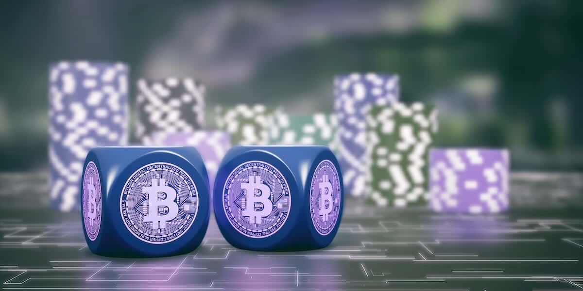 Bitcoin dice and stacks of casino coins on a green surface