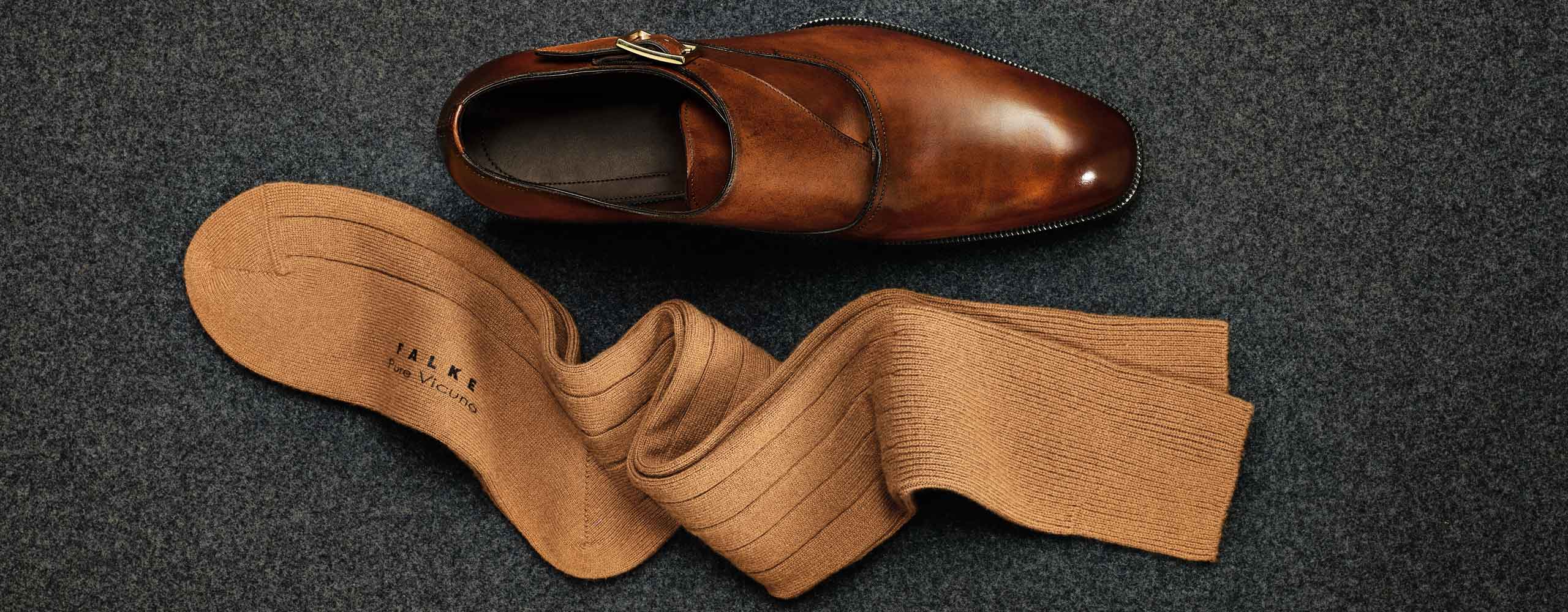 A pair of Falke golden brown sock and a brown shoe