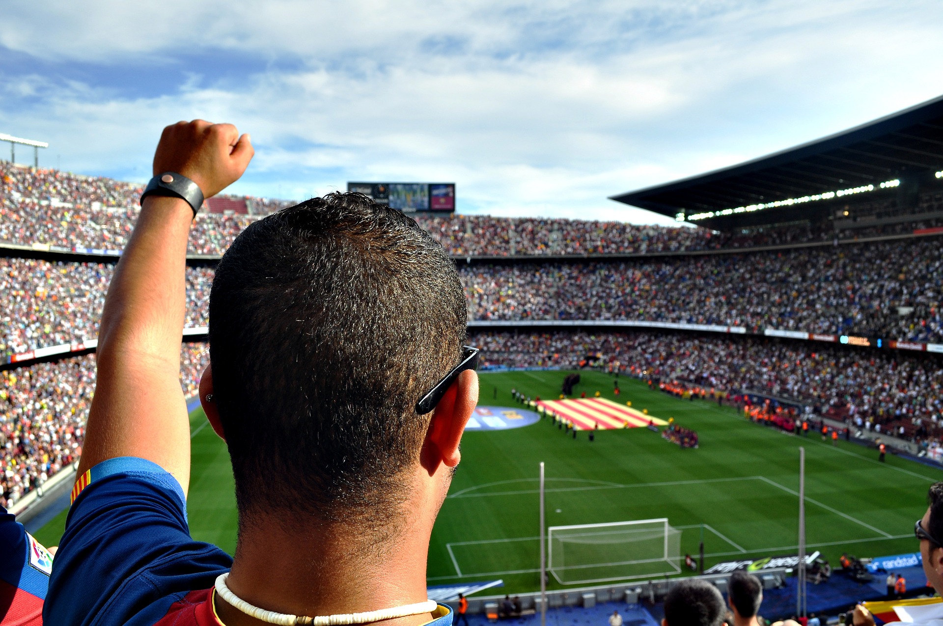 A man is raising hand during football match