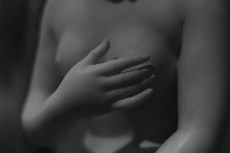 Woman Hand Covering Breasts