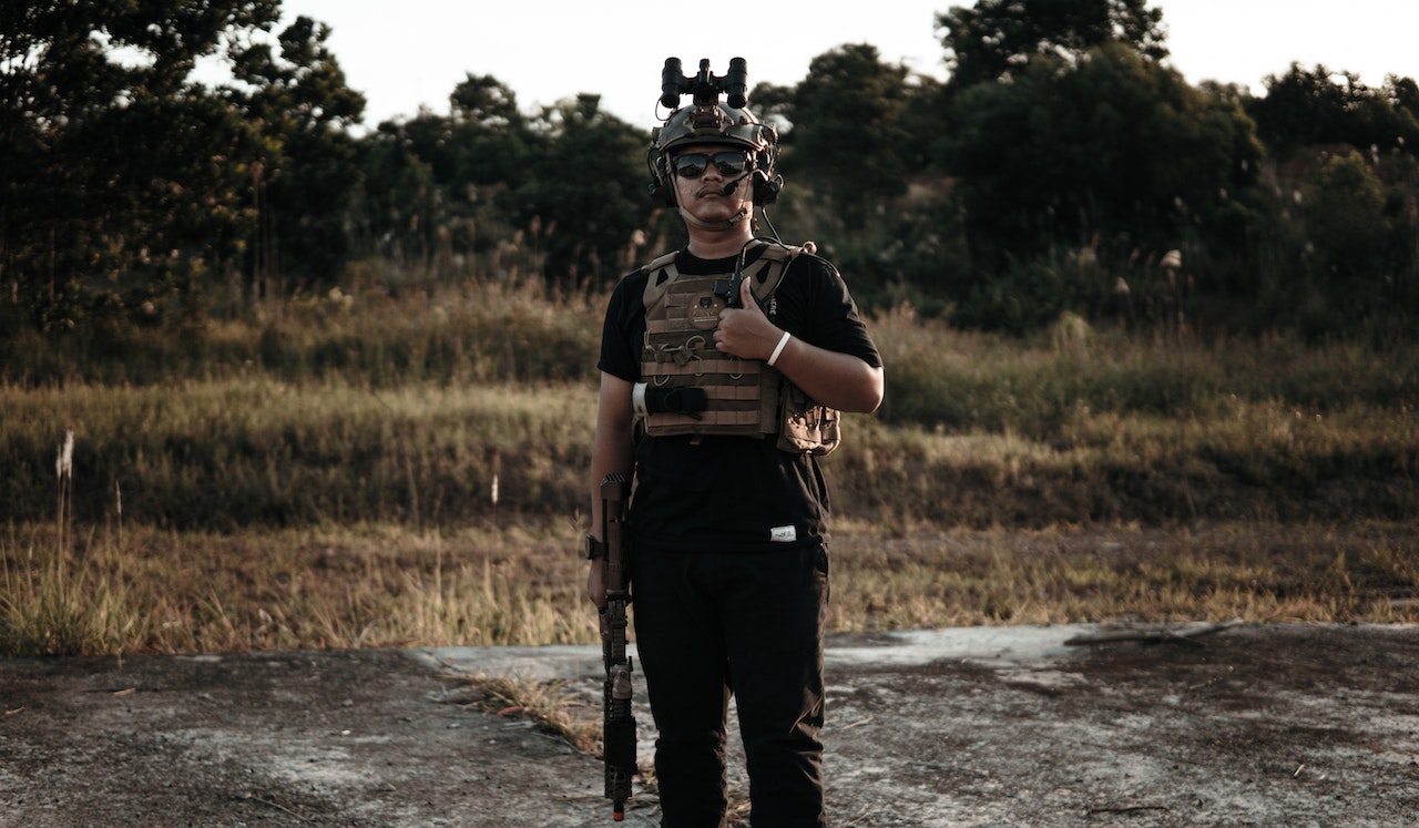  Man with a Bulletproof Vest and holding a rifle Doing a Thumbs Up