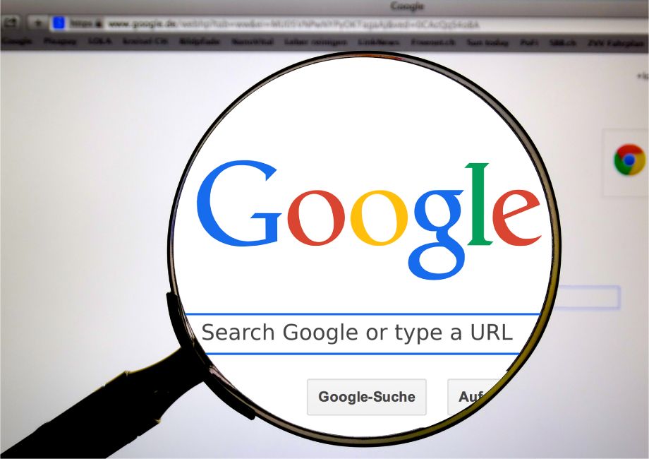 A magnifying glass showing Search Google or type a URL google box