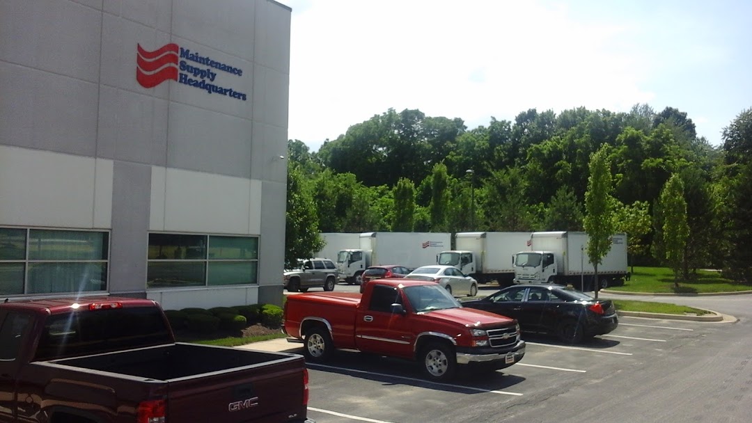 Cars parked next to Maintenance Supply Headquarters building