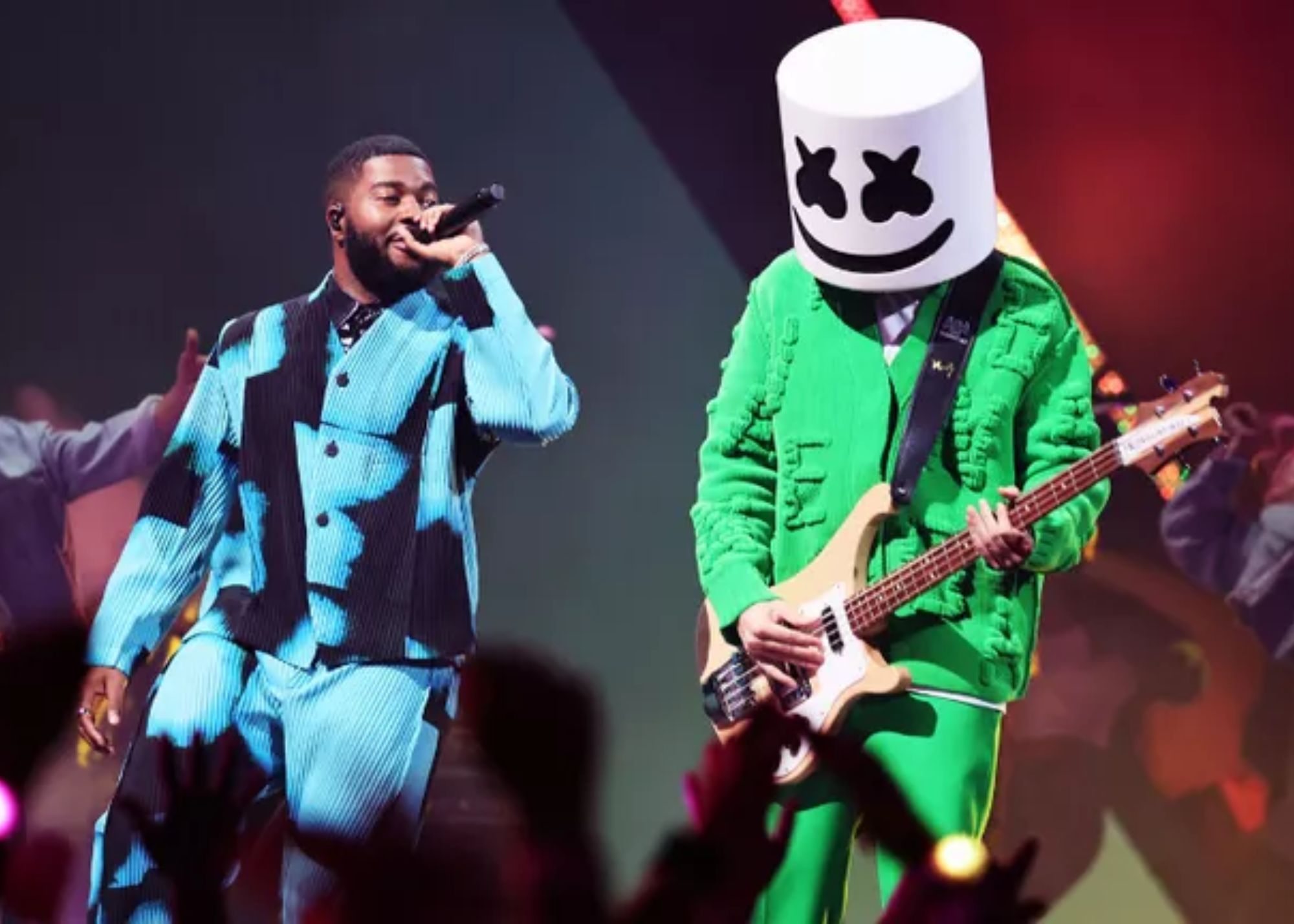 Marshmello is attired in a green outfit with an electric guitar, while Khalid is suited up in a sky blue patch outfit