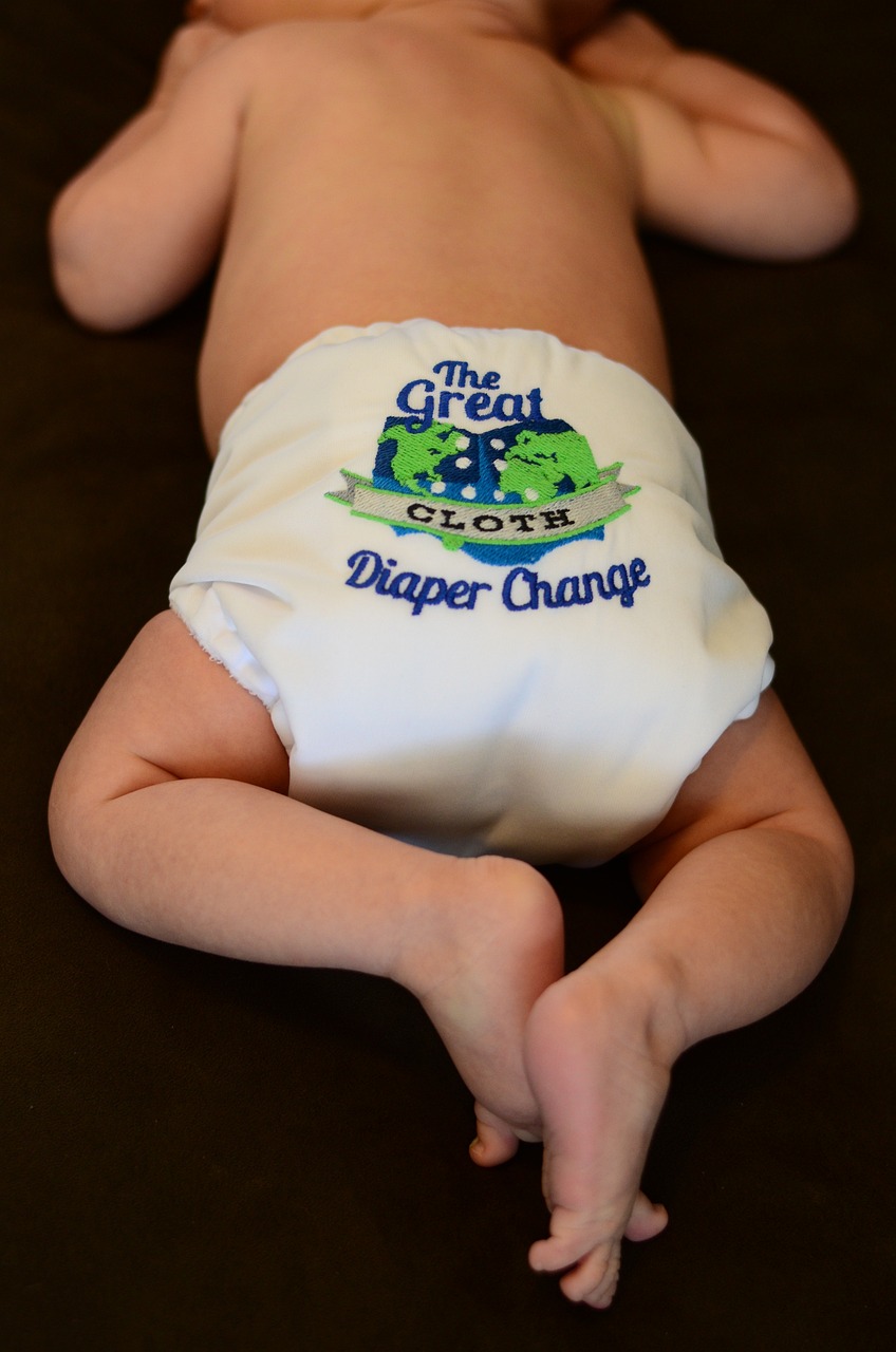 Baby with nappy that says the great cloth diaper change