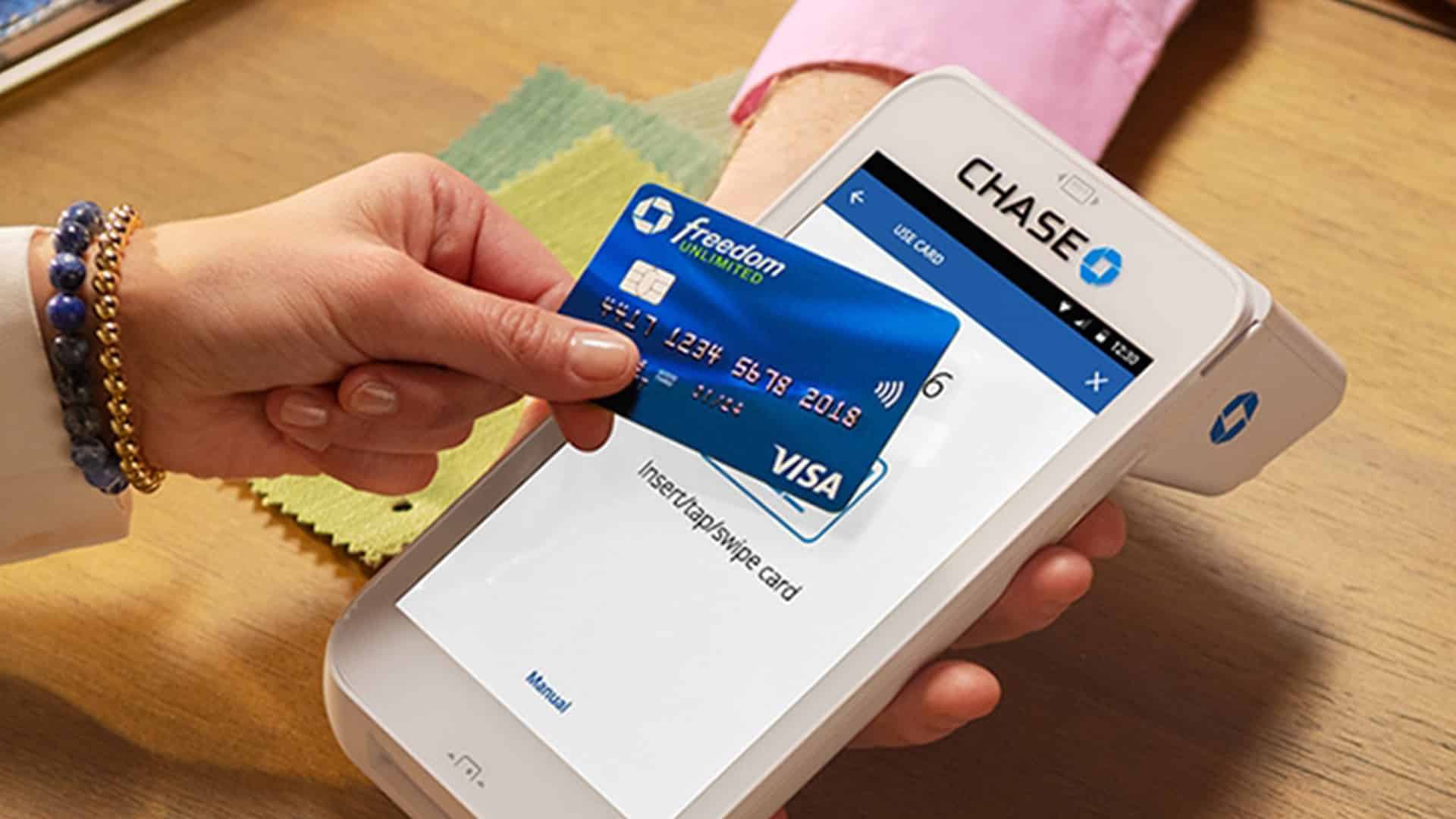 A person holding a VISA card and another person holding Chase card machine 