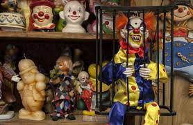 Clown motel scary puppets arranged on a rack