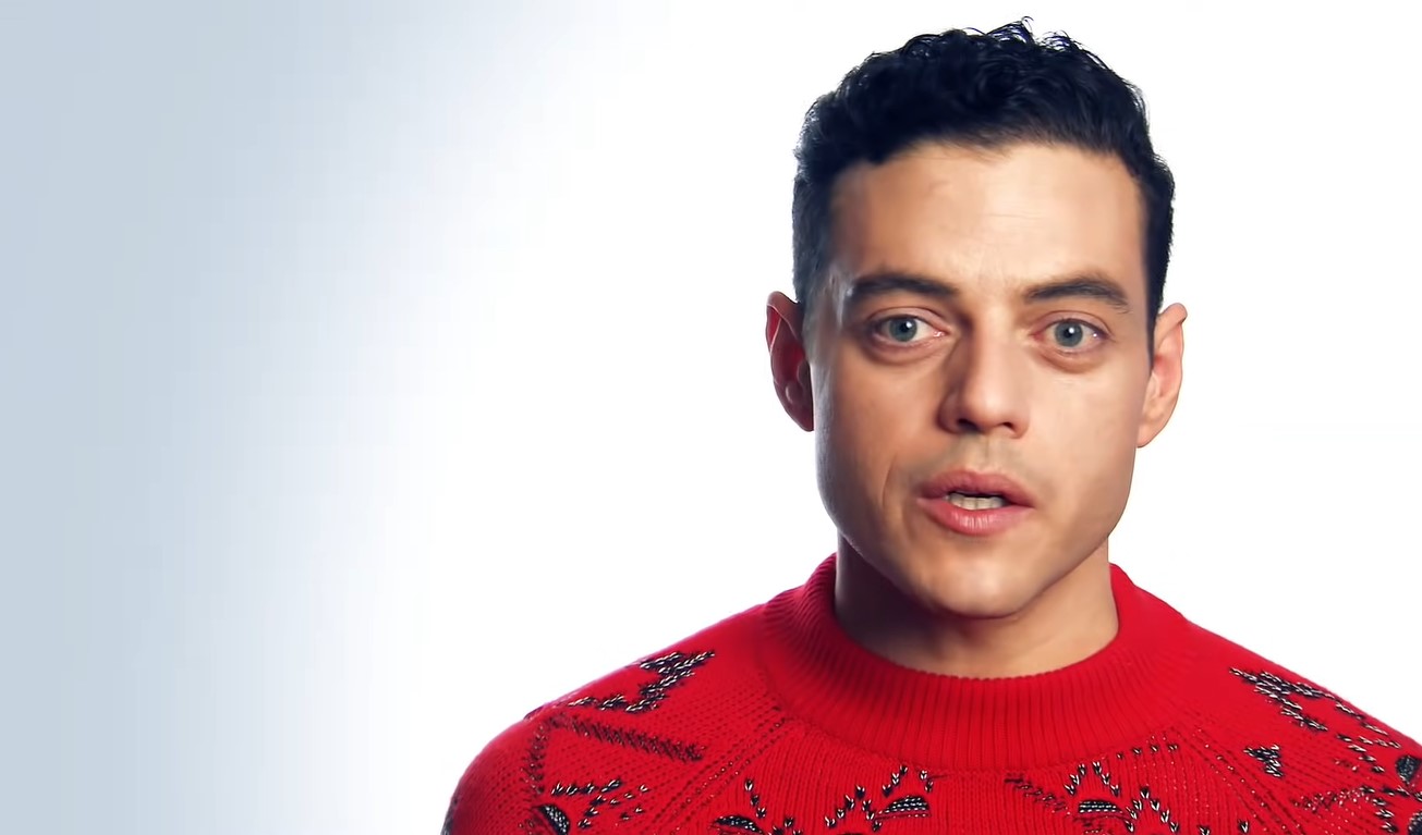 Blue-eyed Rami Malek in a red sweater with stitched designs
