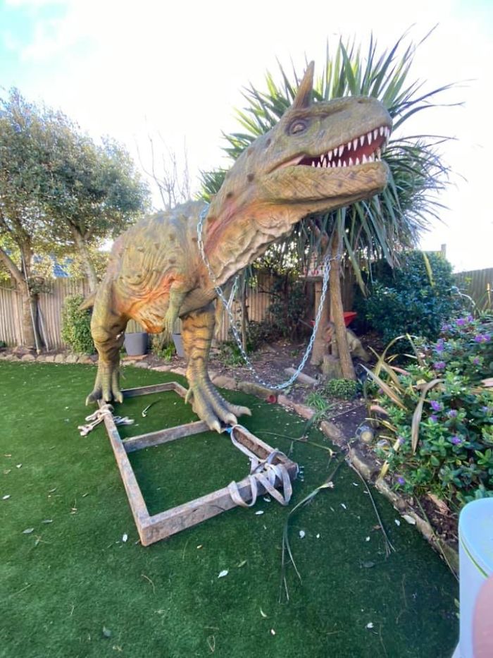 Gigantic dinosaur toy in a house yard