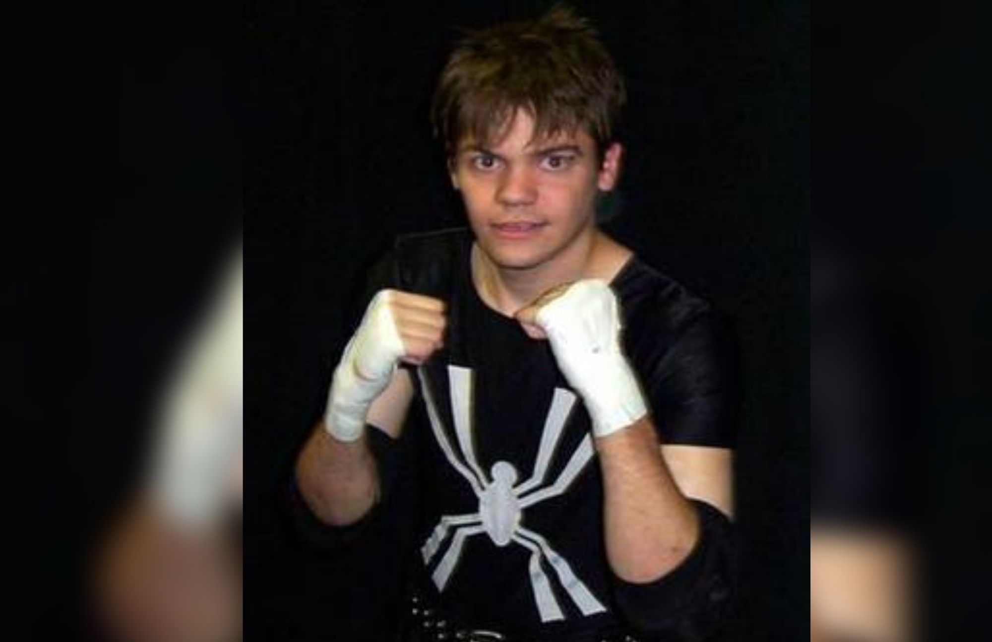 Daniel "Spider" Quirk is clothed in a spider-themed black shirt, with his hands level and his elbows tucked in his sides