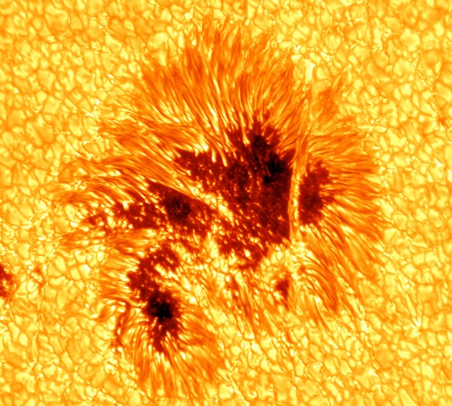 A closest image of sun comprising of dark orange and yellow-orange colored texture