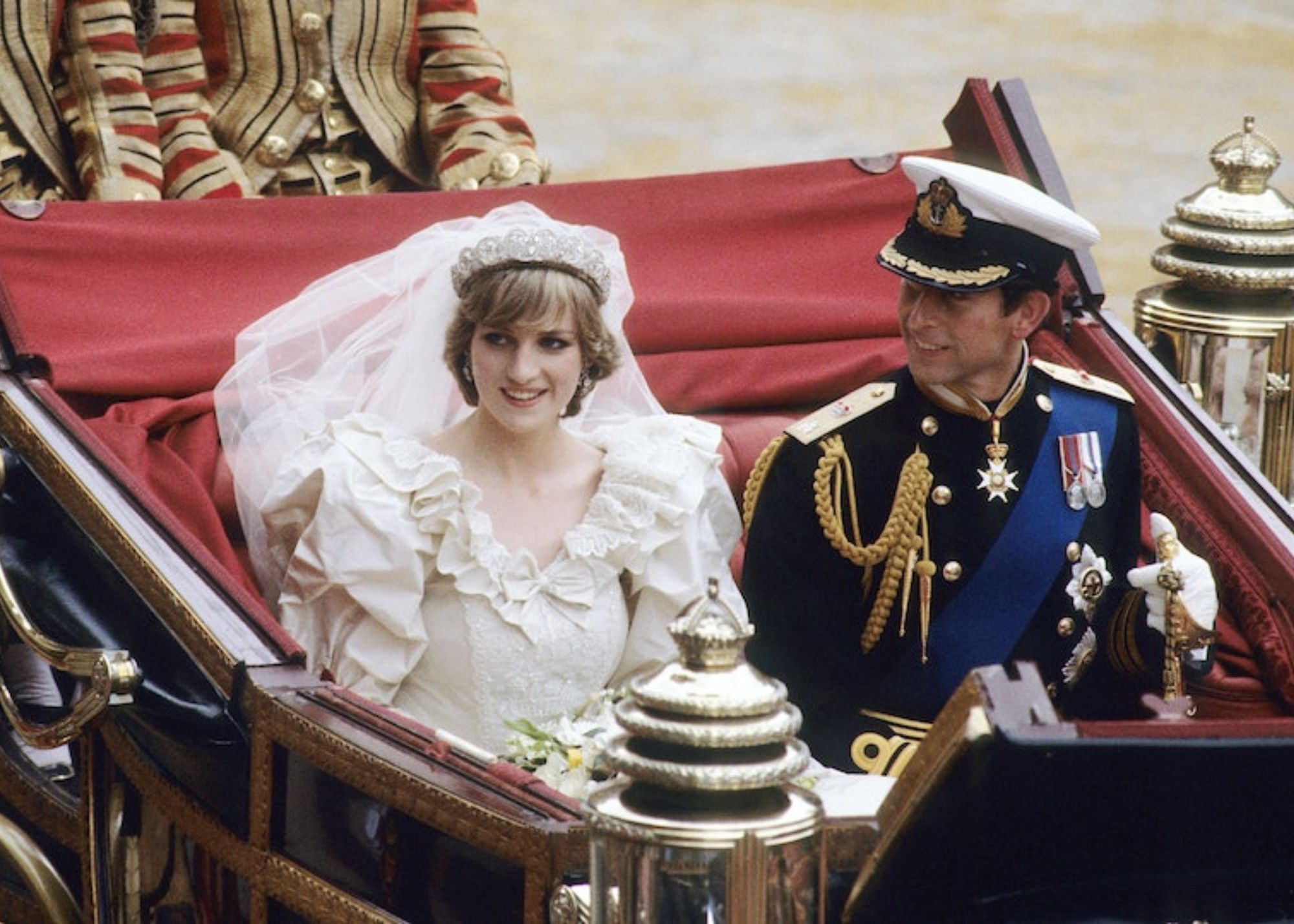 Princess Diana and Prince Charles are dressed in wedding attire and smiling at the crowds